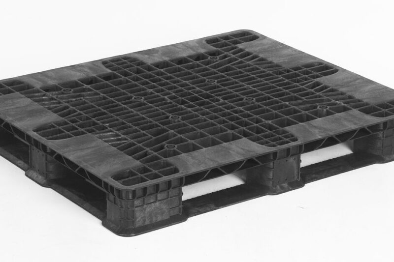 A 40 x 48 STACK’R LD SOLID DECK black plastic pallet with four-way entry rests on a white background.
