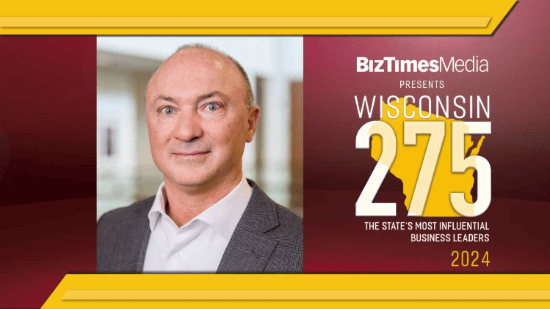 Chris Drees stands beside a BizTimes Media announcement, celebrating Wisconsin's 275 most influential business leaders of 2024, including notable figures from Menasha Corporation.